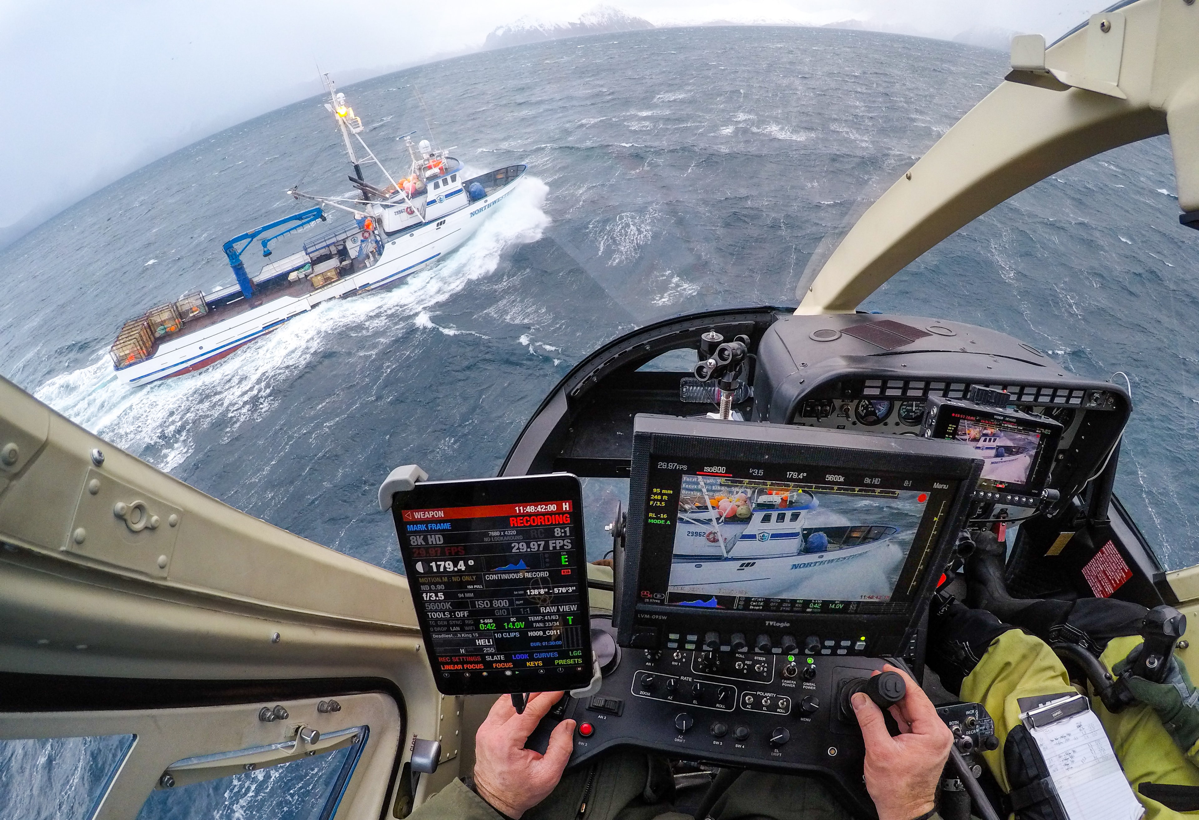POV cockpit shot tracking the Northwestern crab boat in rough Bering Sea swells, 8K camera controls in hand